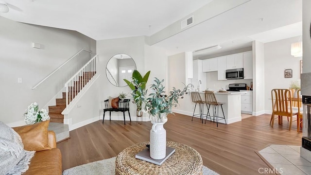 13133 Le Parc Unit 503, Chino Hills, CA 91709 - living area featuring stairway and light wood-style flooring