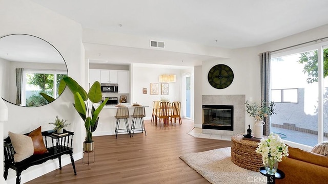 13133 Le Parc Unit 503, Chino Hills, CA 91709 - living area with a high end fireplace, light wood-style floors, and plenty of natural light