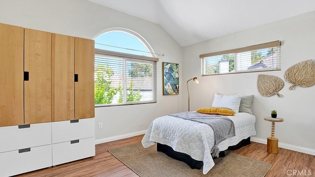 13133 Le Parc Unit 503, Chino Hills, CA 91709 - bedroom with multiple windows, vaulted ceiling, and light wood-style flooring