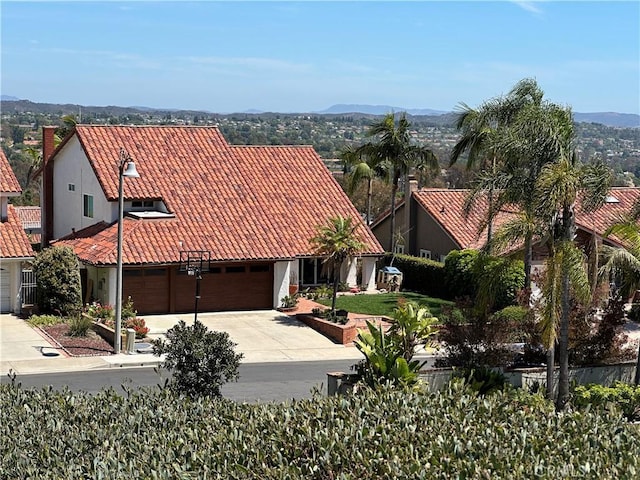 22792 Orellana, Mission Viejo, CA 92691 - view of front of house with a tile roof, concrete driveway, stucco siding, a mountain view, and an attached garage