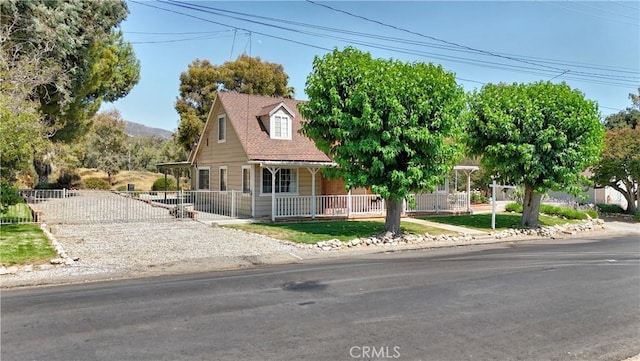 1023 Fremont St, Calimesa, CA 92320 - new england style home with a fenced front yard and covered porch
