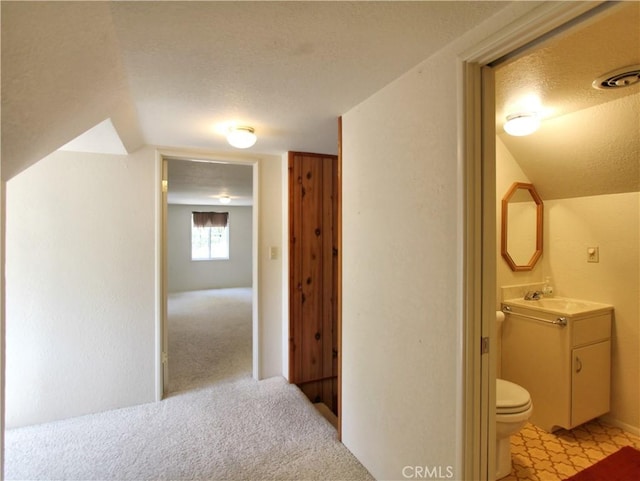 1023 Fremont St, Calimesa, CA 92320 - corridor featuring a textured ceiling, light colored carpet, and lofted ceiling