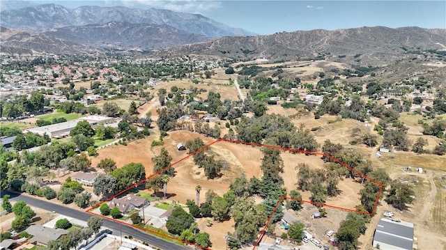 1023 Fremont St, Calimesa, CA 92320 - aerial view of property and surrounding area featuring a mountain backdrop and property parcel outlined
