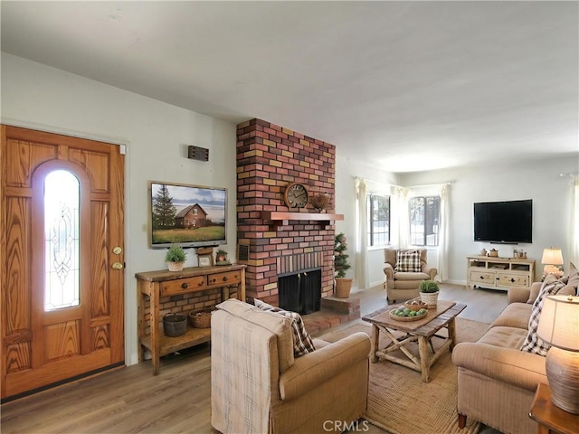 1023 Fremont St, Calimesa, CA 92320 - living area featuring light wood-type flooring, plenty of natural light, and a brick fireplace