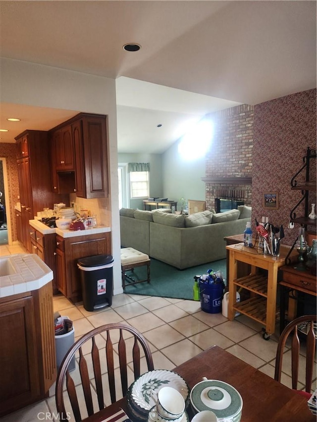 3082 Copa De Oro Dr, Los Alamitos, CA 90720 - dining room with light tile patterned floors and a brick fireplace