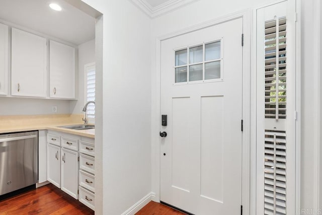 1833 Stonebrook Ln, Encinitas, CA 92024 - kitchen with stainless steel dishwasher, white cabinetry, light countertops, crown molding, and dark wood-style flooring