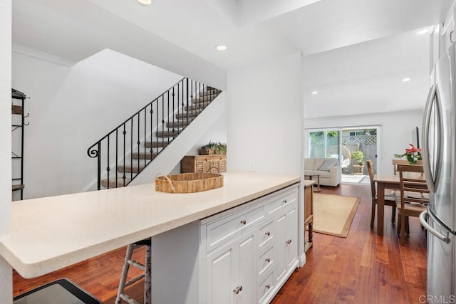 1833 Stonebrook Ln, Encinitas, CA 92024 - kitchen featuring white cabinets, dark wood-type flooring, recessed lighting, light countertops, and a kitchen breakfast bar