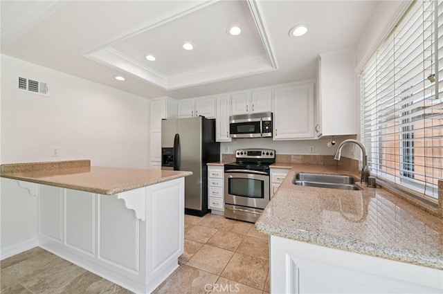 1984 Mount Shasta Dr, San Pedro, CA 90732 - kitchen with stainless steel appliances, a raised ceiling, a peninsula, recessed lighting, and light stone counters
