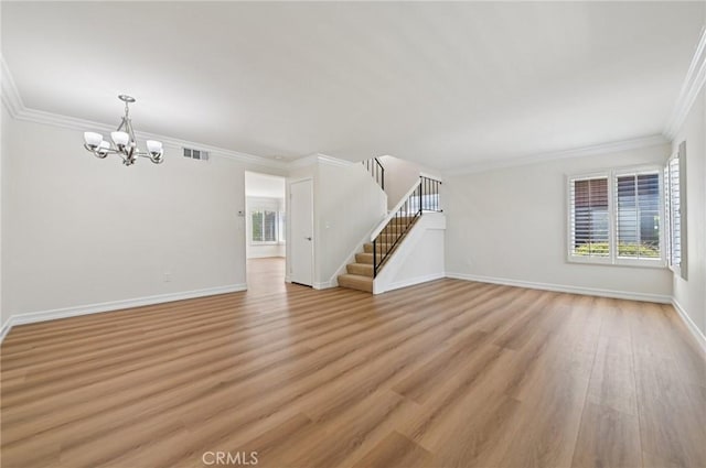 1984 Mount Shasta Dr, San Pedro, CA 90732 - unfurnished living room featuring healthy amount of natural light, a chandelier, light wood-style flooring, and ornamental molding