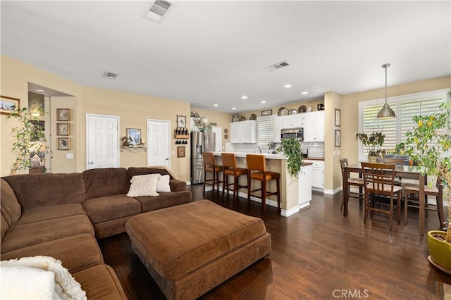 45749 21st St W, Lancaster, CA 93536 - living area featuring dark wood-type flooring and recessed lighting