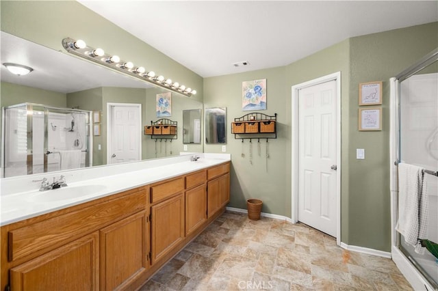 45749 21st St W, Lancaster, CA 93536 - bathroom featuring double vanity, a shower stall, and stone finish flooring