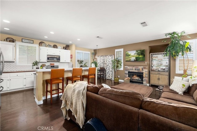 45749 21st St W, Lancaster, CA 93536 - living area featuring dark wood-style flooring, recessed lighting, and a fireplace
