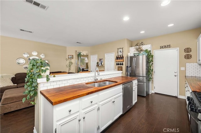 45749 21st St W, Lancaster, CA 93536 - kitchen with wooden counters, stainless steel appliances, open floor plan, white cabinets, and recessed lighting