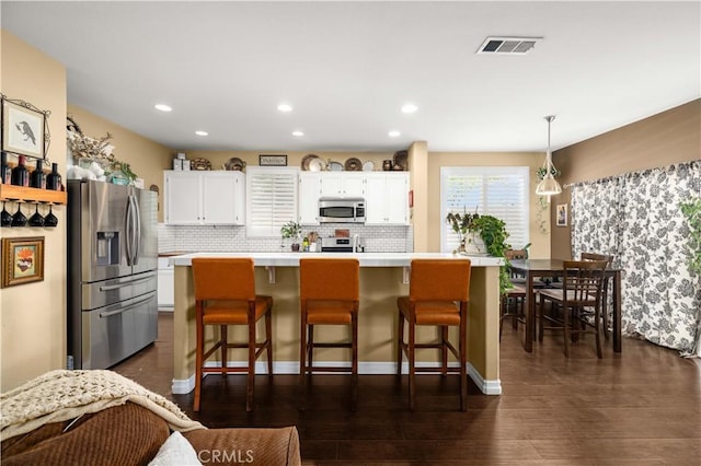 45749 21st St W, Lancaster, CA 93536 - kitchen featuring stainless steel appliances, light countertops, white cabinets, backsplash, and recessed lighting