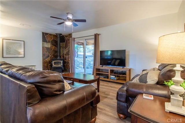 42179 High Point Ct, Ahwahnee, CA 93601 - living room featuring a wood stove, ceiling fan, and wood finished floors