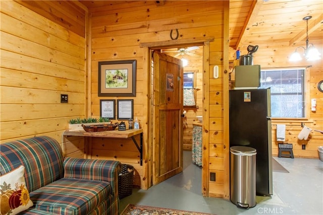 42179 High Point Ct, Ahwahnee, CA 93601 - sitting room featuring wood walls, finished concrete floors, and ceiling fan