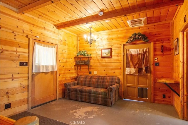 42179 High Point Ct, Ahwahnee, CA 93601 - living area featuring a wood ceiling with exposed beams, wooden walls, a chandelier, and concrete floors