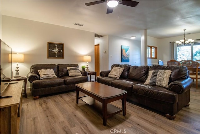 42179 High Point Ct, Ahwahnee, CA 93601 - living room with wood finished floors, a ceiling fan, and a chandelier