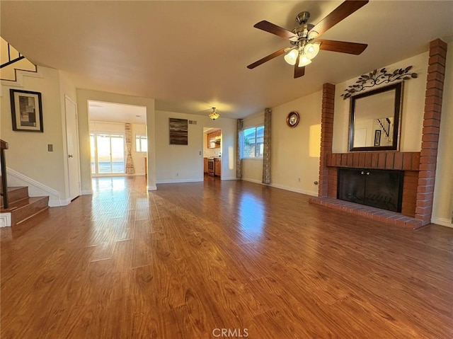 22407 Birds Eye Dr, Diamond Bar, CA 91765 - unfurnished living room with stairs, a ceiling fan, wood finished floors, and a fireplace
