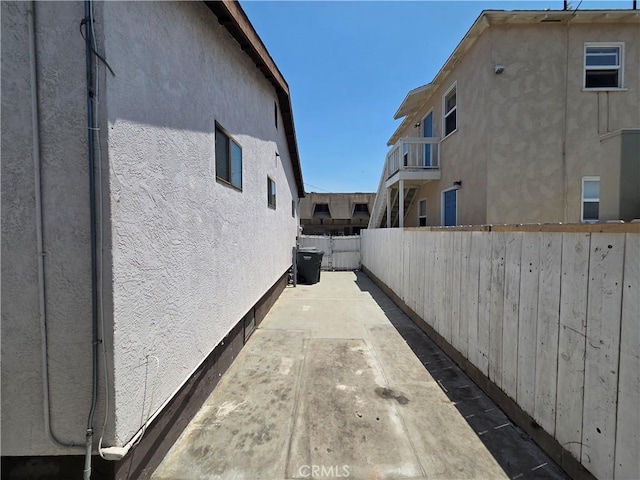 521 E 7th St, National City, CA 91950 - view of side of home with stucco siding and a patio area
