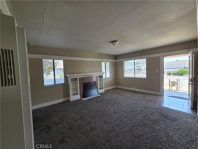 521 E 7th St, National City, CA 91950 - unfurnished living room featuring carpet flooring, a brick fireplace, and tile patterned floors