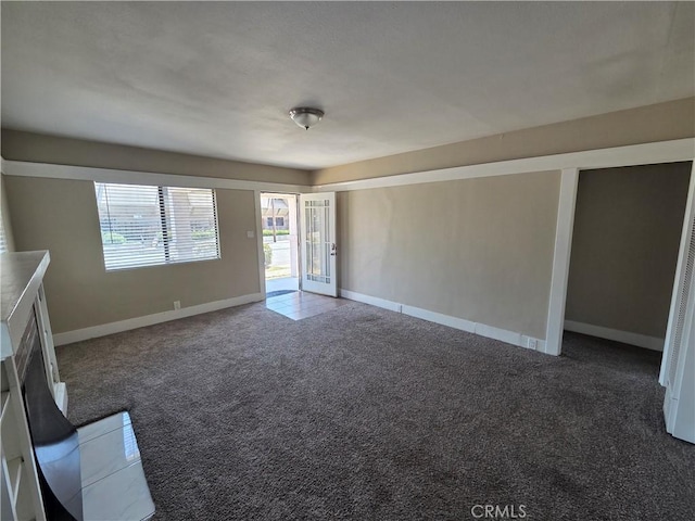 521 E 7th St, National City, CA 91950 - unfurnished living room featuring dark colored carpet