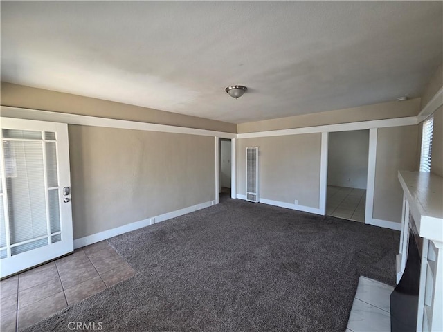 521 E 7th St, National City, CA 91950 - carpeted empty room featuring tile patterned floors and baseboards