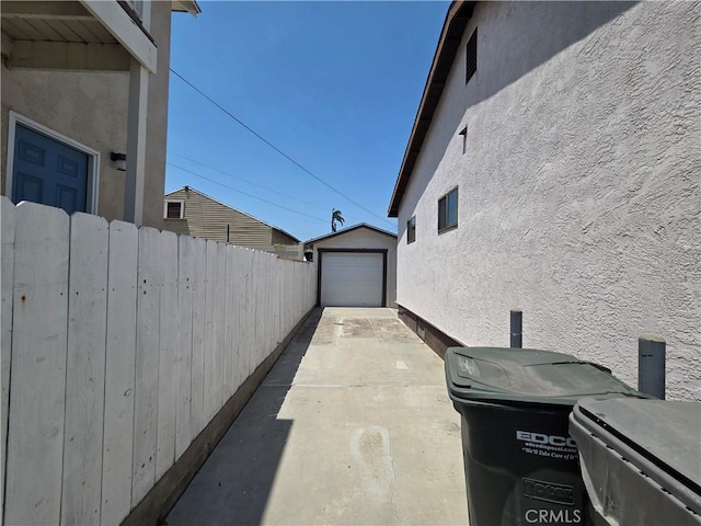 521 E 7th St, National City, CA 91950 - view of patio featuring driveway, an outdoor structure, and a garage