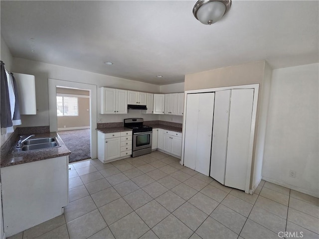 521 E 7th St, National City, CA 91950 - kitchen with stainless steel gas range, dark countertops, light tile patterned flooring, and white cabinetry