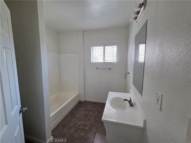 521 E 7th St, National City, CA 91950 - full bathroom with tile patterned flooring, vanity, a shower, and a textured wall