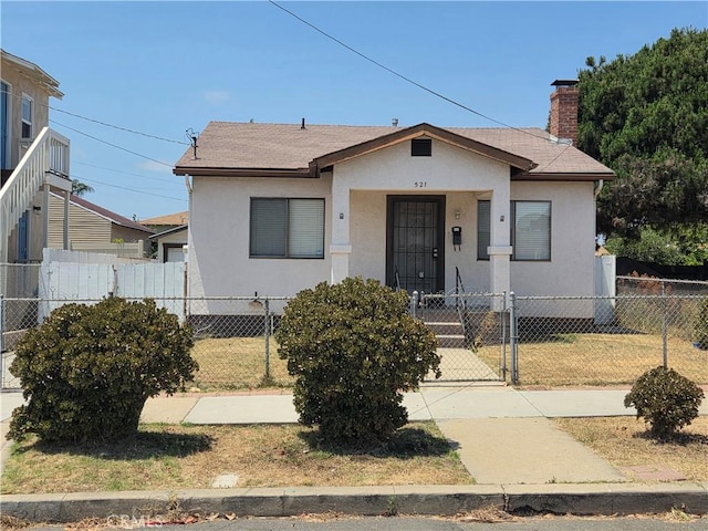 521 E 7th St, National City, CA 91950 - bungalow with stucco siding, a fenced front yard, a gate, and roof with shingles