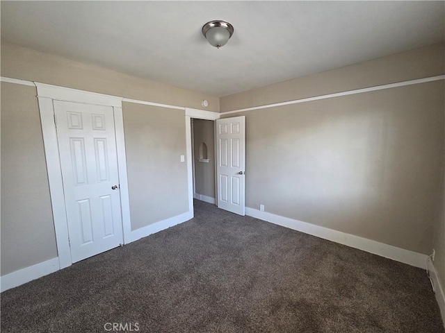 521 E 7th St, National City, CA 91950 - unfurnished bedroom featuring dark carpet and baseboards