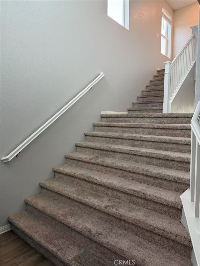 7453 Grazing Ln, Riverside, CA 92507 - staircase with wood finished floors and baseboards
