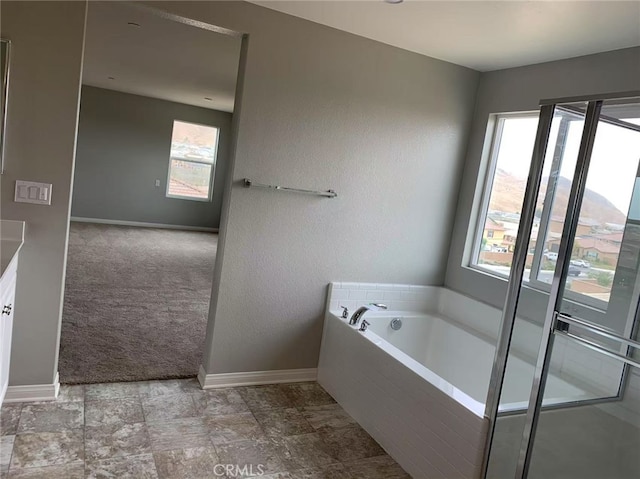 7453 Grazing Ln, Riverside, CA 92507 - bathroom with plenty of natural light, a garden tub, and vanity