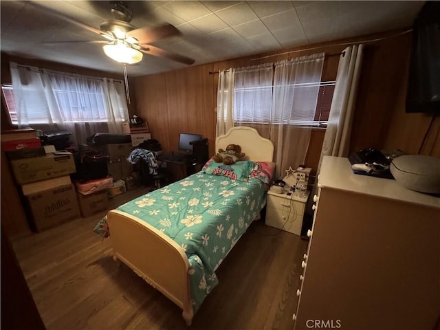 23789 Zuger, Crestline, CA 92325 - bedroom featuring wood finished floors, wooden walls, and a ceiling fan