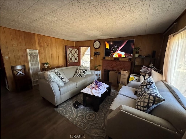23789 Zuger, Crestline, CA 92325 - living room featuring a heating unit, wooden walls, wood finished floors, and a brick fireplace