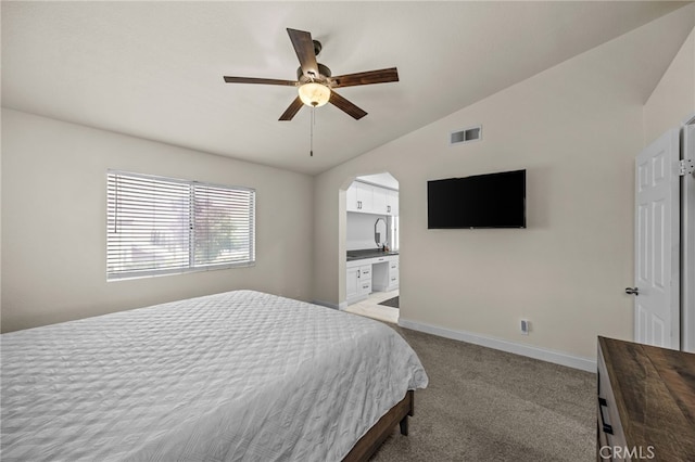 13106 Thicket Pl, Corona, CA 92883 - bedroom featuring vaulted ceiling, light carpet, a ceiling fan, arched walkways, and ensuite bath