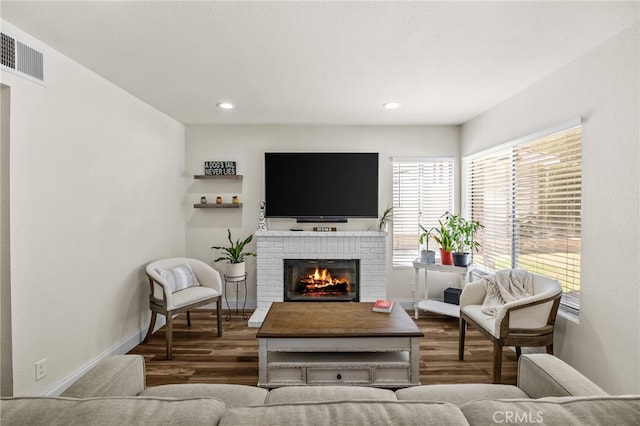 13106 Thicket Pl, Corona, CA 92883 - living area featuring wood finished floors, a brick fireplace, and recessed lighting