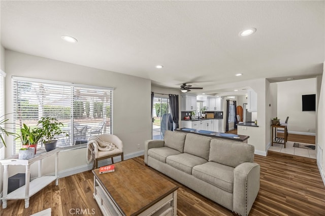 13106 Thicket Pl, Corona, CA 92883 - living room featuring recessed lighting, dark wood finished floors, ceiling fan, arched walkways, and a textured ceiling