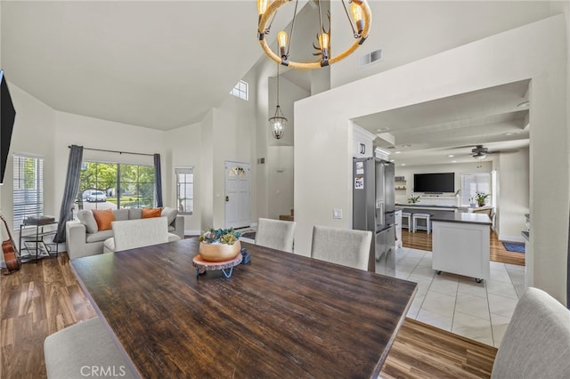 13106 Thicket Pl, Corona, CA 92883 - dining space featuring a chandelier, a high ceiling, healthy amount of natural light, and ceiling fan