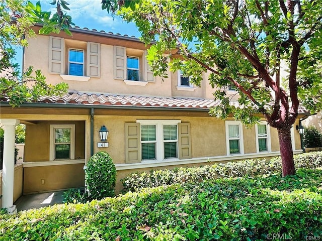 41 Keepsake, Irvine, CA 92618 - rear view of house featuring stucco siding and a tiled roof
