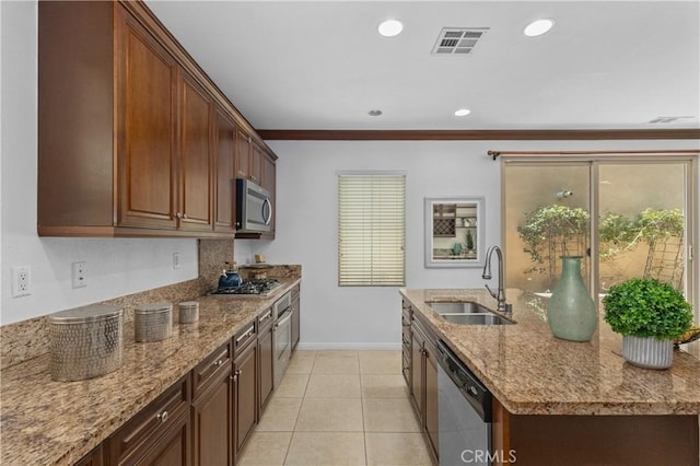 41 Keepsake, Irvine, CA 92618 - kitchen featuring appliances with stainless steel finishes, light stone countertops, light tile patterned floors, an island with sink, and recessed lighting
