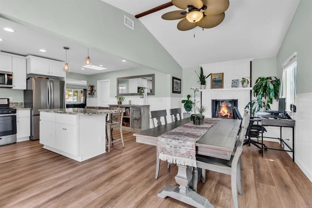 552 Emory St, Imperial Beach, CA 91932 - dining room with ceiling fan, a brick fireplace, light wood-style flooring, and recessed lighting