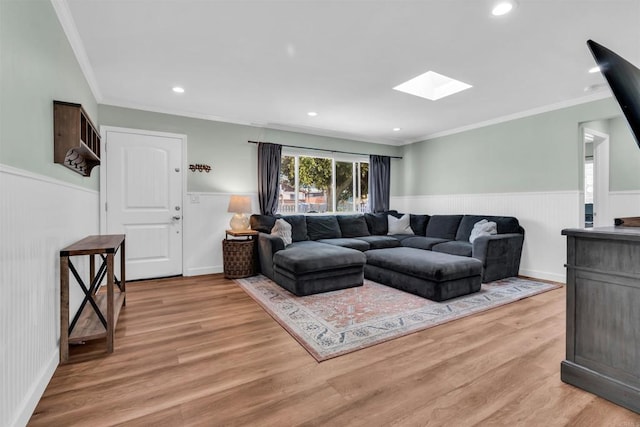 552 Emory St, Imperial Beach, CA 91932 - living room featuring a skylight, a wainscoted wall, ornamental molding, light wood-type flooring, and recessed lighting