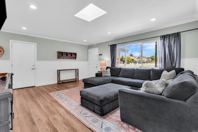 552 Emory St, Imperial Beach, CA 91932 - living room featuring crown molding, a skylight, wainscoting, light wood-style floors, and recessed lighting