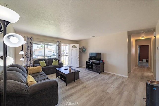24561 Sinaloa St, Moreno Valley, CA 92557 - living area with light wood-style floors and a textured ceiling