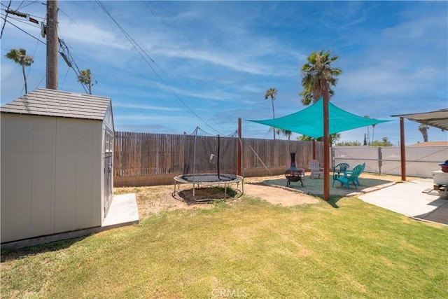 24561 Sinaloa St, Moreno Valley, CA 92557 - fenced backyard with a shed, a patio area, a trampoline, and a fire pit