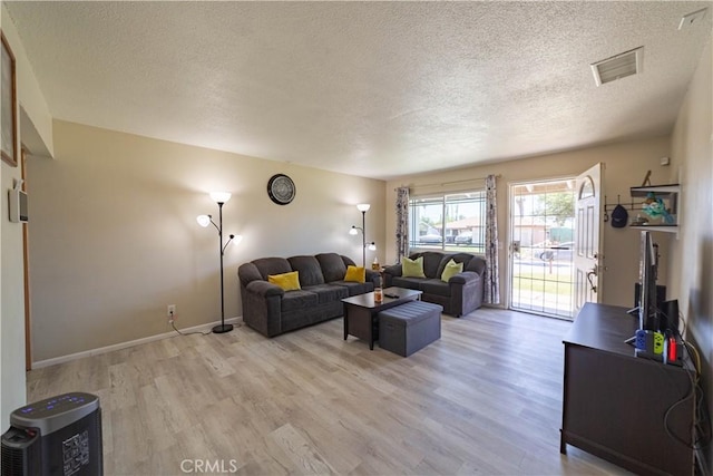 24561 Sinaloa St, Moreno Valley, CA 92557 - living room featuring a textured ceiling and light wood finished floors