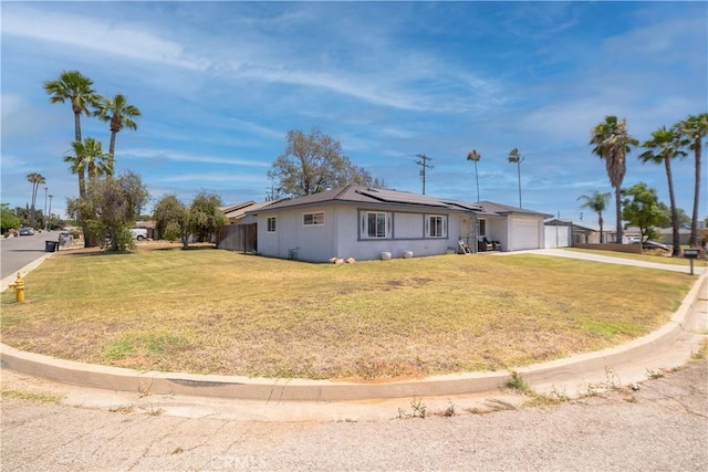 24561 Sinaloa St, Moreno Valley, CA 92557 - ranch-style home with a garage, roof mounted solar panels, driveway, and a front lawn