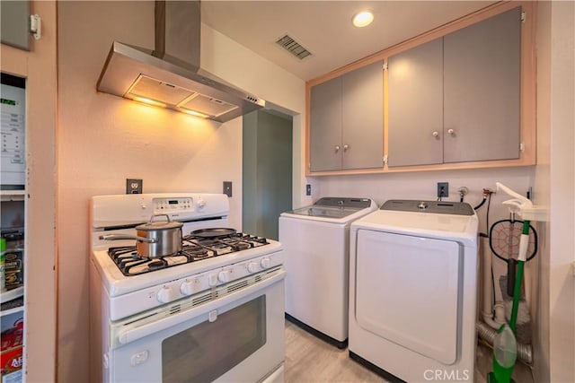 24561 Sinaloa St, Moreno Valley, CA 92557 - washroom featuring washing machine and clothes dryer, light wood finished floors, and recessed lighting